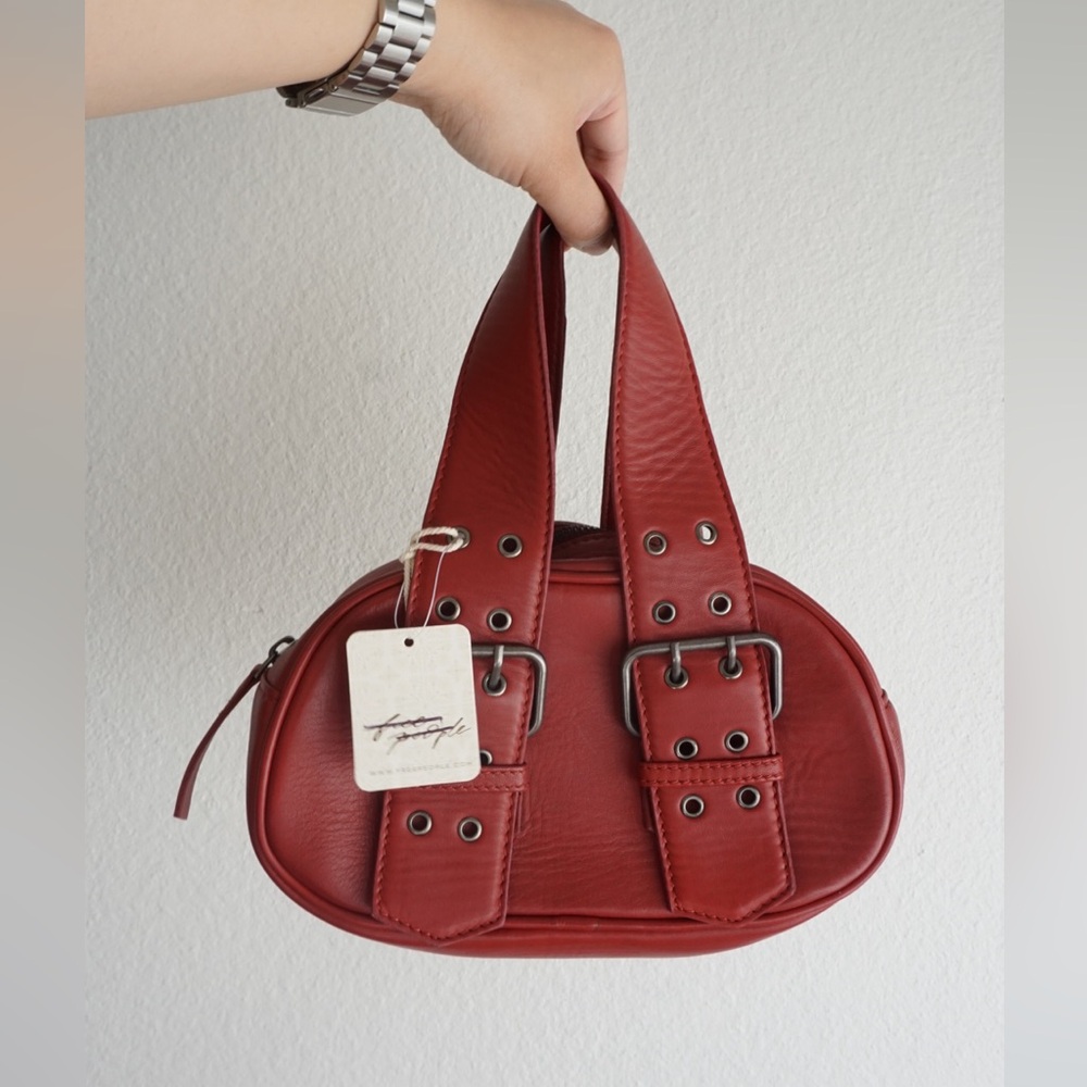 Red say yes bag; mini leather bag with silver buckle detailing and two handles
